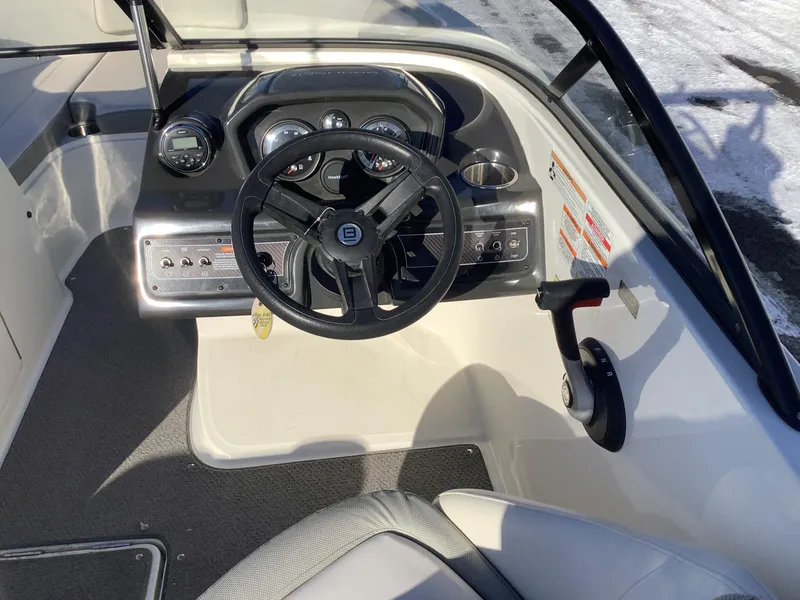 Slide: The Image of 2016 Bayliner VR6 boat cockpit with steering wheel and control panel. - 33