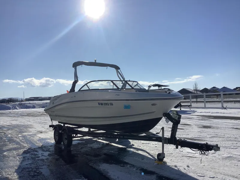 Slide: The Image of 2016 Bayliner VR6 boat on trailer in snowy landscape under bright sun. - 4