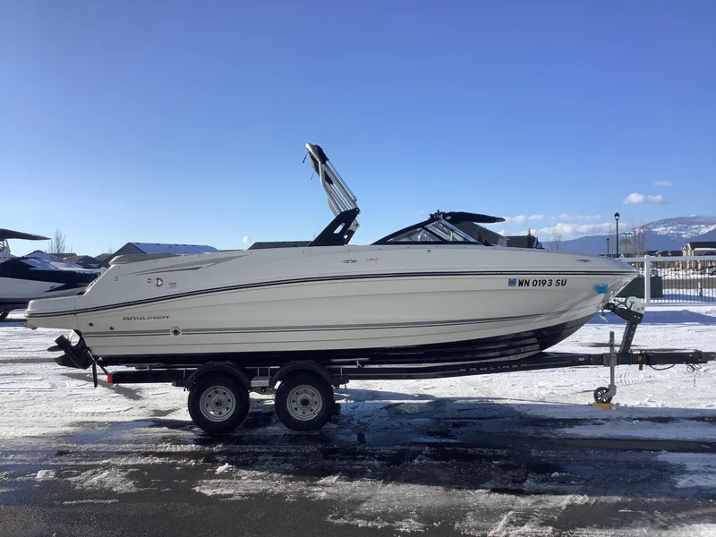 Slide: The Image of 2016 Bayliner VR6 boat on trailer in snowy landscape under clear blue sky. - 5