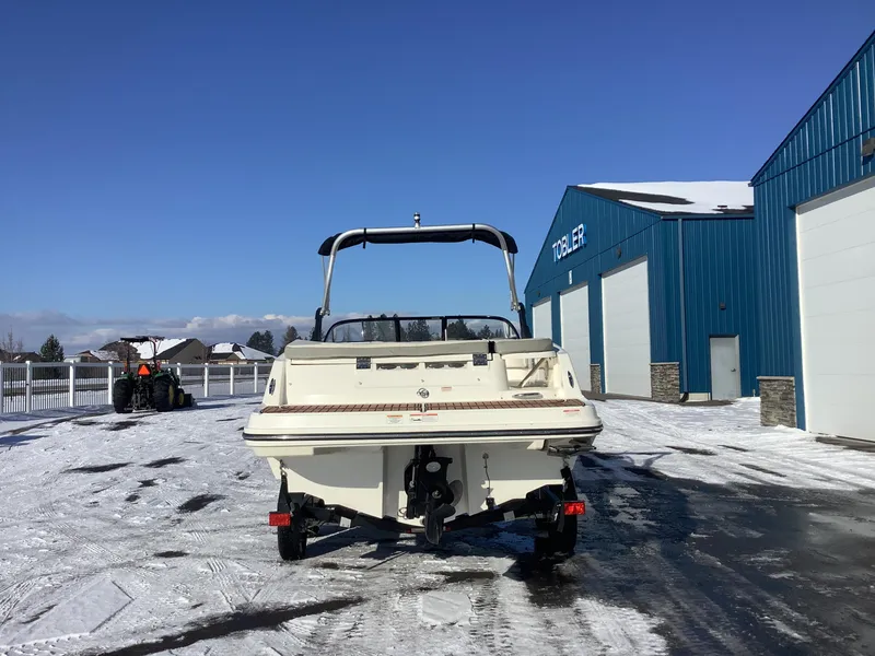 Slide: The Image of 2016 Bayliner VR6 boat on snowy lot near blue building. - 7