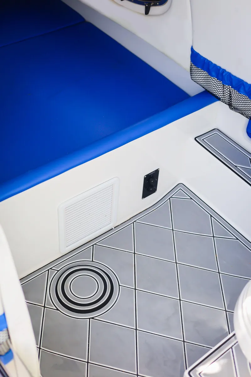 Slide: The Image of 2020 Nor-Tech 340 interior with blue seating and patterned flooring. - 12