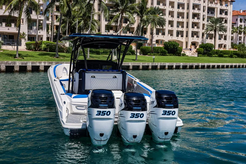 Slide: The Image of 2020 Nor-Tech 340 boat with triple 350 engines, docked near waterfront buildings. - 5