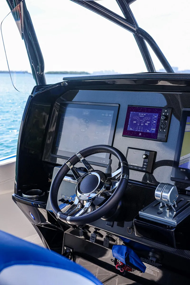Slide: The Image of 2020 Nor-Tech 340 boat dashboard with modern navigation and control systems. - 9