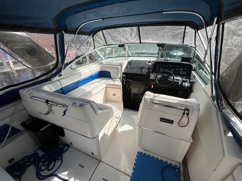 Slide: The Image of 1992 Chaparral Signature 30 boat interior with blue and white seating and steering console. - 24
