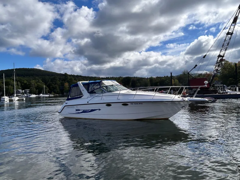 Slide: The Image of 1992 Chaparral Signature 30 boat on a calm lake under a cloudy sky. - 3