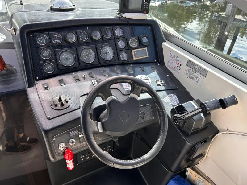 Slide: The Image of Control panel of a 1992 Chaparral Signature 30 boat with steering wheel and gauges. - 33