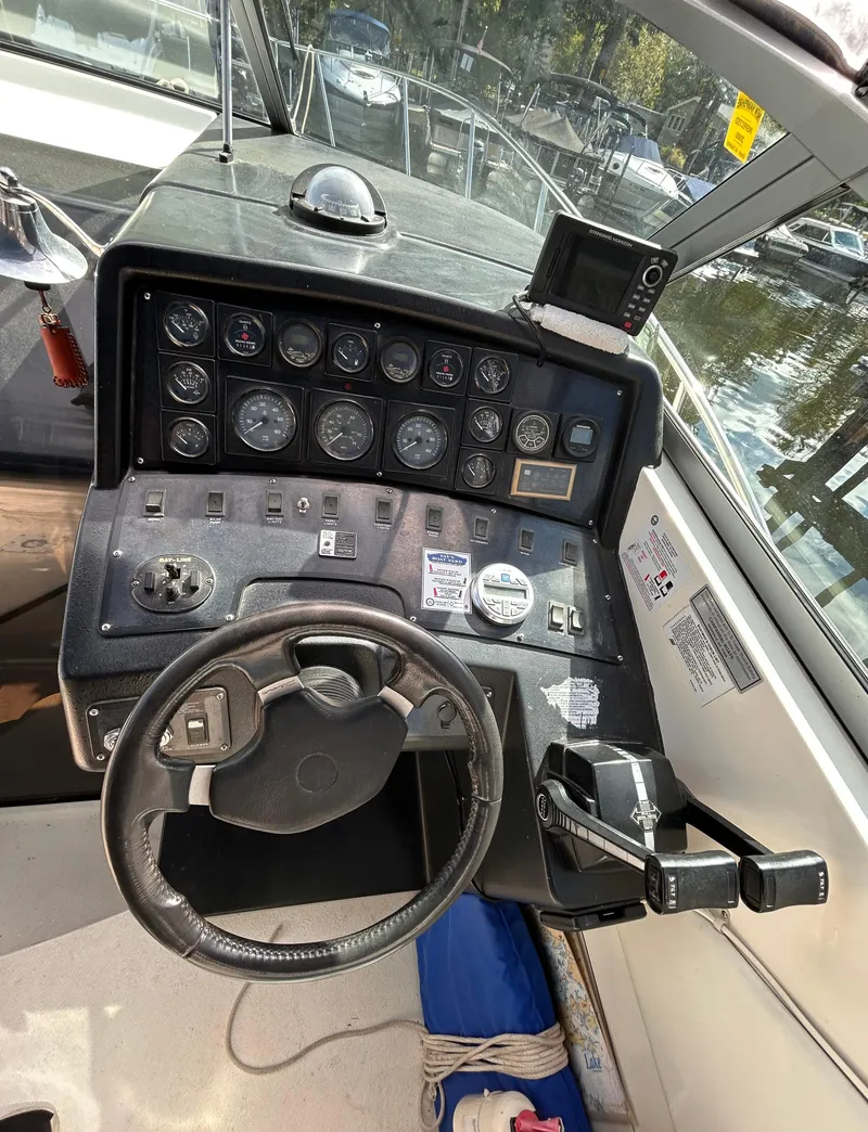 Slide: The Image of 1992 Chaparral Signature 30 boat dashboard with steering wheel and control panel. - 34