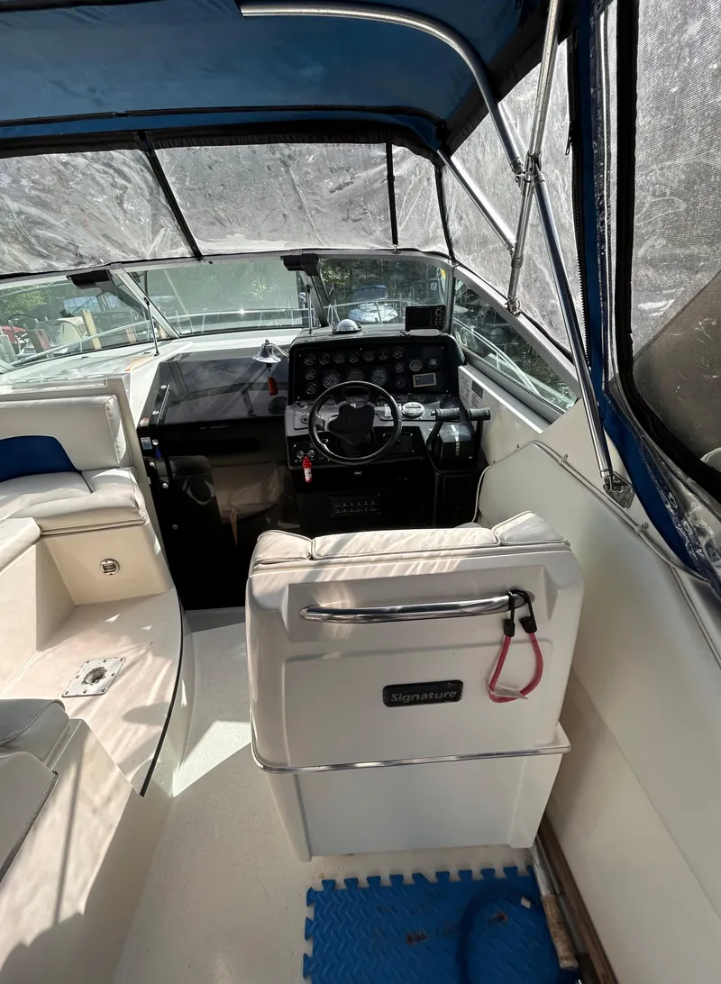 Slide: The Image of Interior view of 1992 Chaparral Signature 30 boat cockpit with steering wheel and seating. - 36