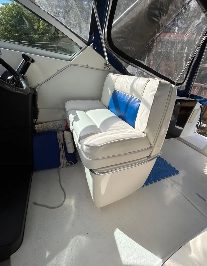 Slide: The Image of Interior of 1992 Chaparral Signature 30 boat with white and blue seating. - 40