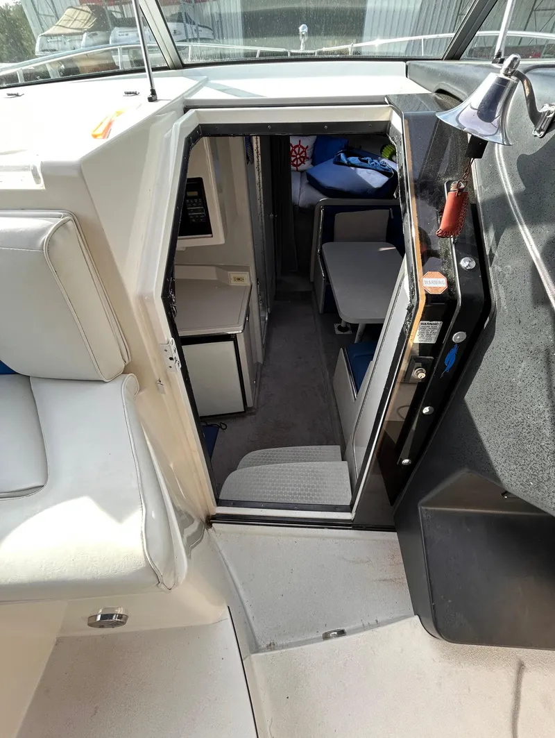 Slide: The Image of Interior view of 1992 Chaparral Signature 30 boat cabin with seating and controls. - 41