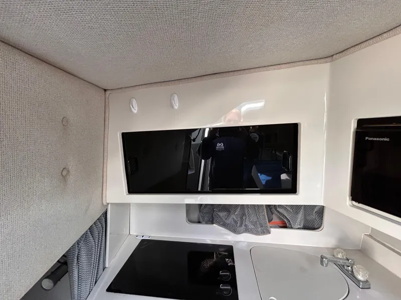 Slide: The Image of Interior of 1992 Chaparral Signature 30 boat with modern kitchenette and appliances. - 45