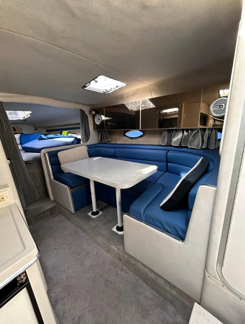 Slide: The Image of 1992 Chaparral Signature 30 interior with blue seating and dining table. - 49