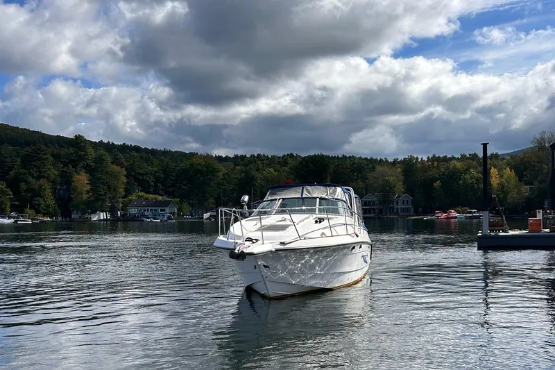 Slide: The Image of Chaparral Signature 30 boat from 1992 on a serene lake under cloudy skies. - 5