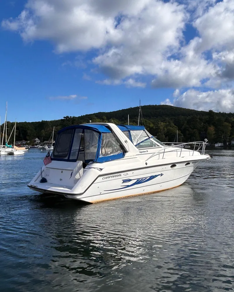 Slide: The Image of 1992 Chaparral Signature 30 boat on a serene lake with a scenic backdrop. - 6