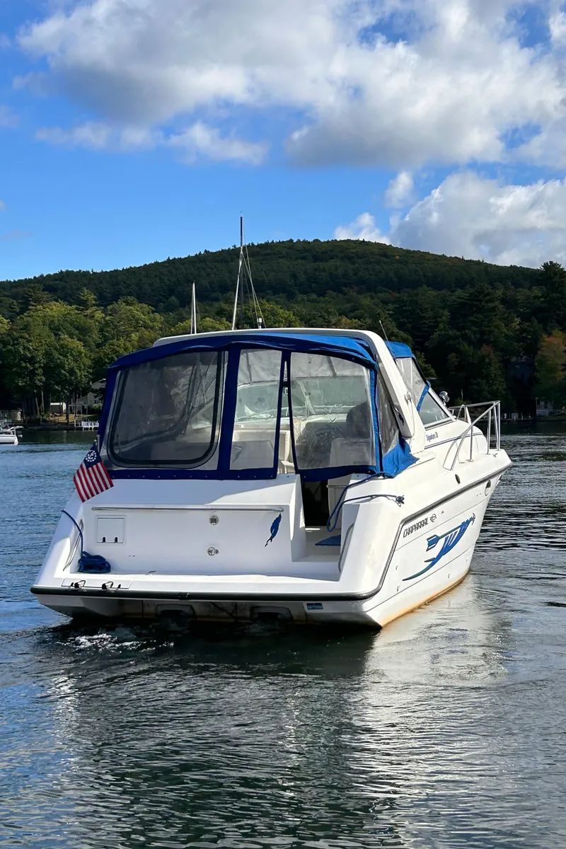 Slide: The Image of 1992 Chaparral Signature 30 boat on a lake with scenic forested hills. - 7