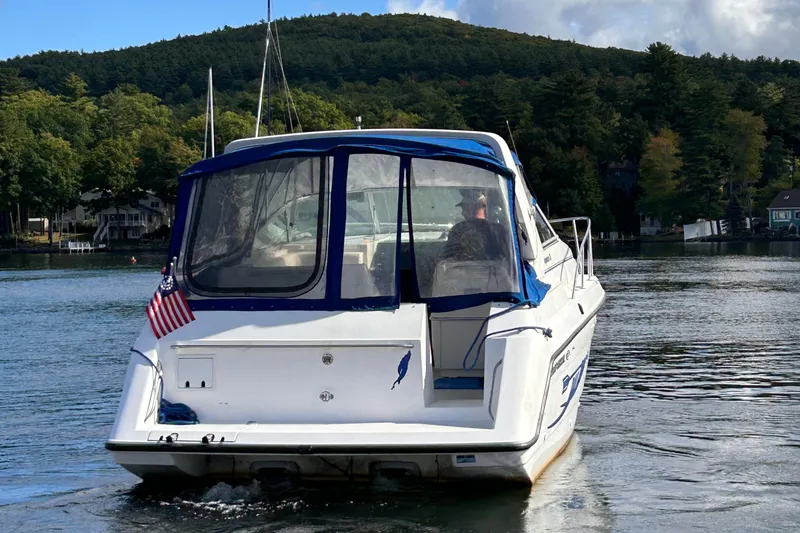 Slide: The Image of 1992 Chaparral Signature 30 boat on a lake, surrounded by lush green hills. - 8