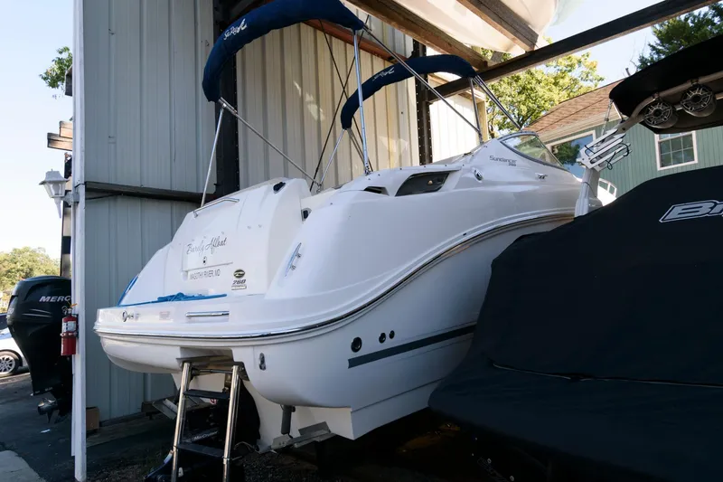 The Image of 2011 Sea Ray 260 Sundancer boat docked in a marina, rear view. - 0