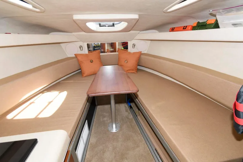 Slide: The Image of Interior of 2011 Sea Ray 260 Sundancer boat with cozy seating and table. - 12