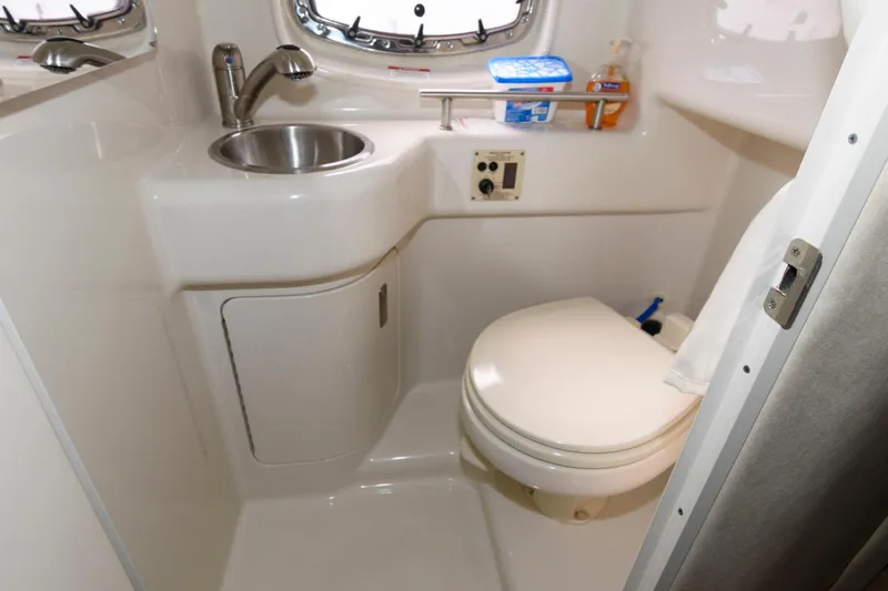 Slide: The Image of Compact bathroom in 2011 Sea Ray 260 Sundancer boat with sink and toilet. - 14