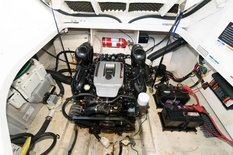 Slide: The Image of Engine compartment of 2011 Sea Ray 260 Sundancer boat, featuring a well-maintained motor. - 15