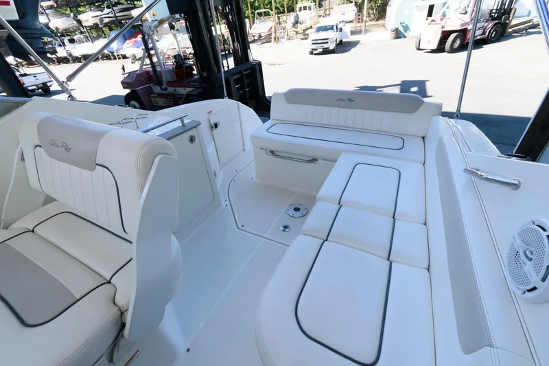 Slide: The Image of 2011 Sea Ray 260 Sundancer boat interior with white seating and sleek design. - 2