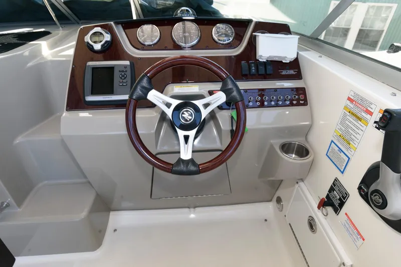 Slide: The Image of 2011 Sea Ray 260 Sundancer helm with steering wheel and instrument panel. - 8