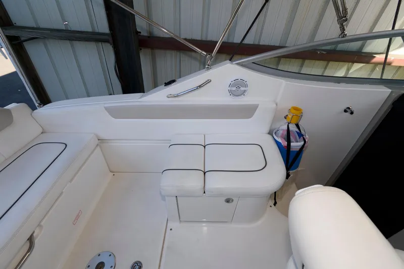 Slide: The Image of 2011 Sea Ray 260 Sundancer boat interior with white seating and storage. - 9