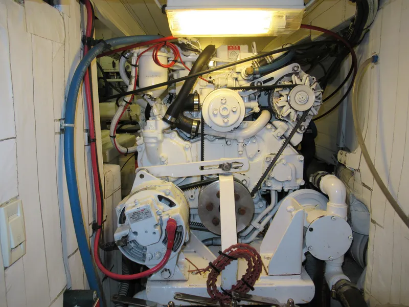 Slide: The Image of Engine room of 2002 Northern Marine Pilothouse Sloop, featuring complex machinery and wiring. - 18