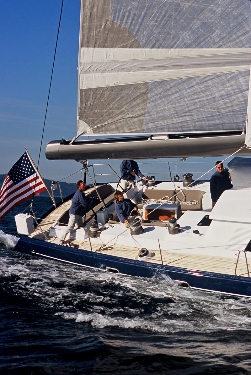 Slide: The Image of Sailing on a 2002 Northern Marine Pilothouse Sloop with crew and American flag. - 19