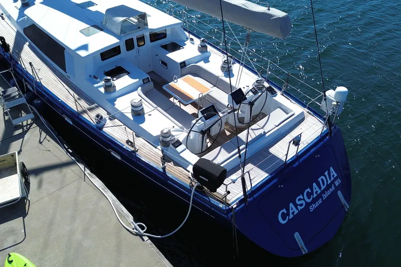Slide: The Image of Northern Marine 2002 Pilothouse Sloop "Cascadia" docked, featuring spacious deck and sleek design. - 20