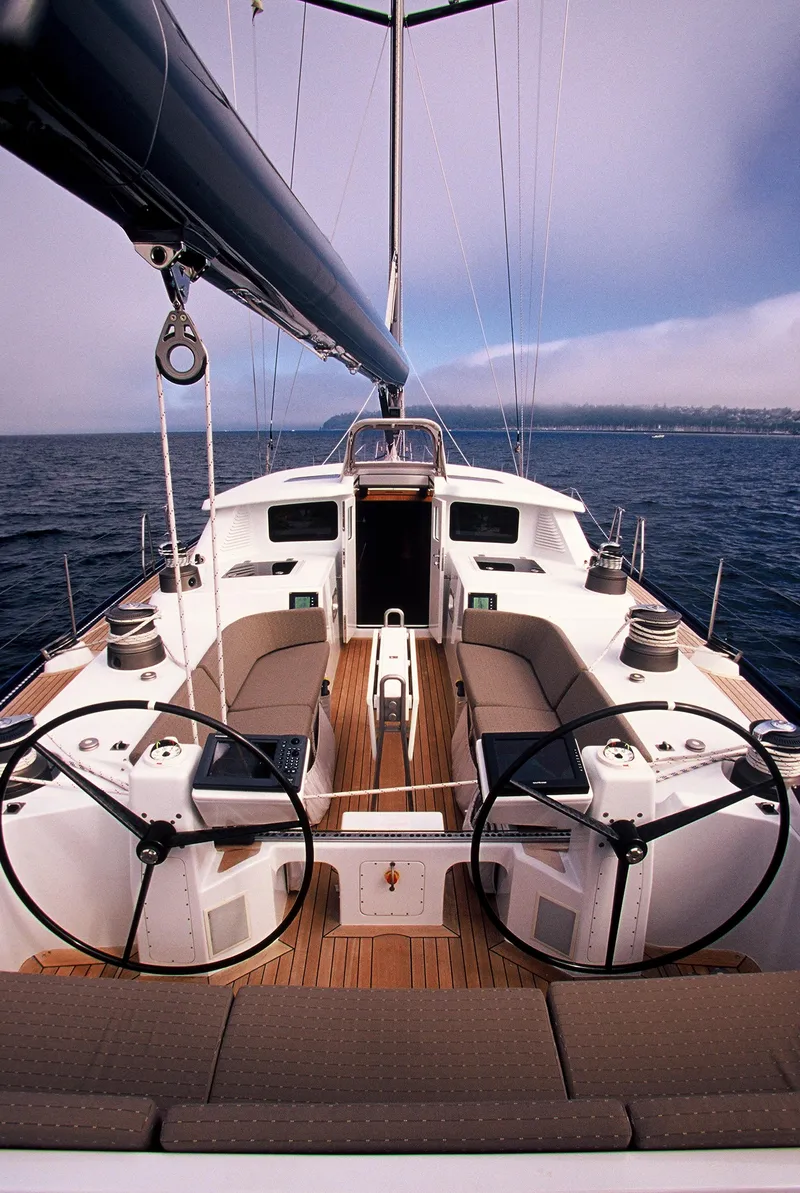 Slide: The Image of 2002 Northern Marine Pilothouse Sloop sailing on open water, featuring dual steering wheels. - 22
