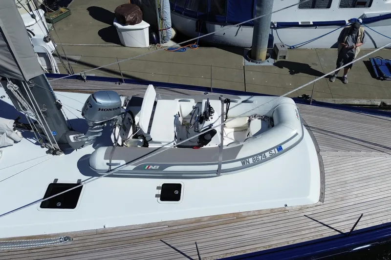 Slide: The Image of 2002 Northern Marine Pilothouse Sloop with inflatable dinghy and Honda outboard motor. - 25