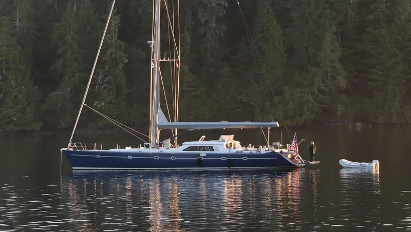 Slide: The Image of 2002 Northern Marine Pilothouse Sloop anchored on calm water with forest backdrop. - 27