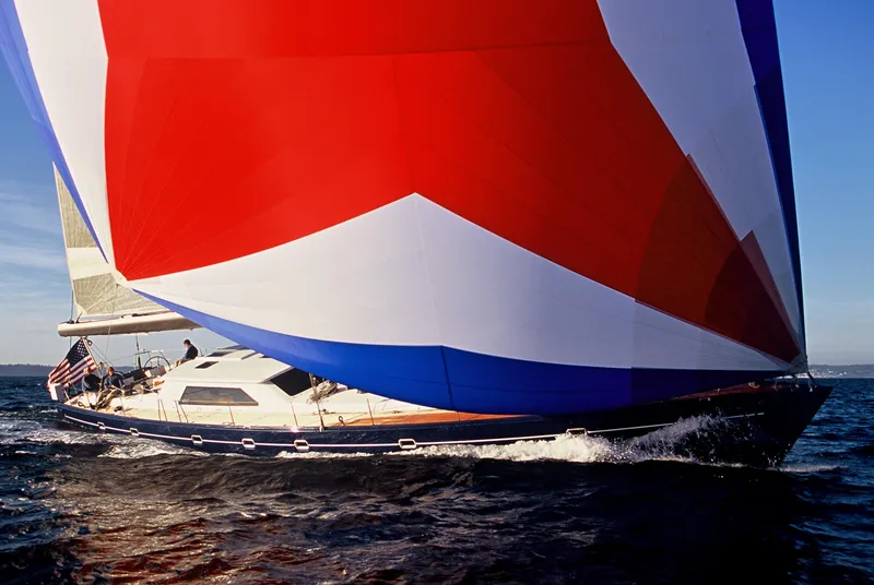 Slide: The Image of 2002 Northern Marine Pilothouse Sloop sailing with vibrant red, white, and blue spinnaker. - 4