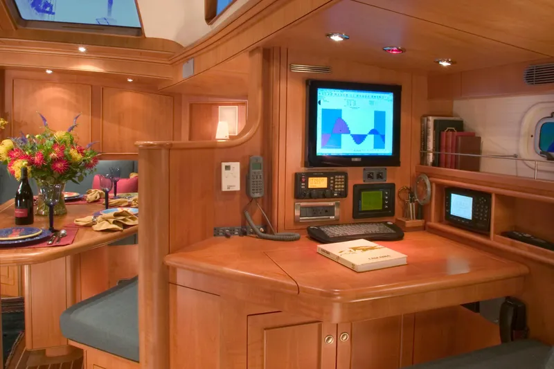 Slide: The Image of Luxurious 2002 Northern Marine Pilothouse Sloop interior with navigation equipment and elegant dining setup. - 9