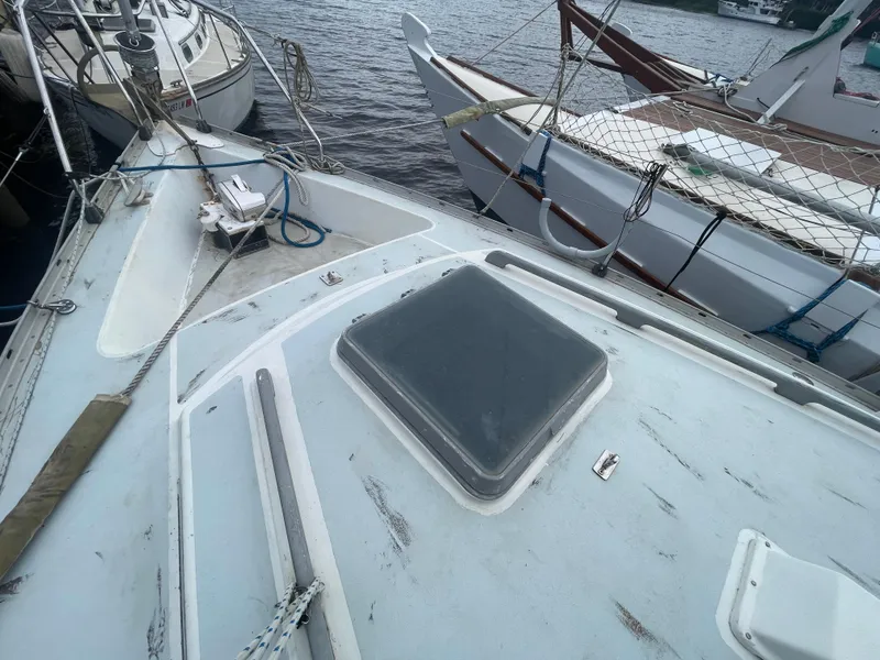 Slide: The Image of 1979 Moody 36 Classic sailboat deck, docked with other boats. - 11