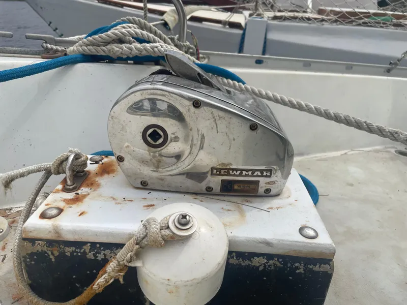 Slide: The Image of Lewmar winch on 1979 Moody 36 Classic sailboat deck, with ropes and rust. - 12