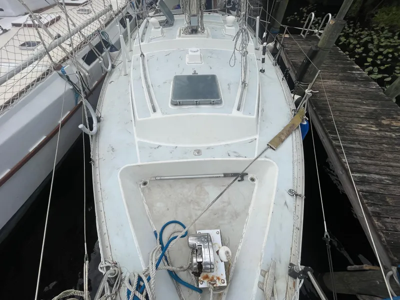 Slide: The Image of 1979 Moody 36 Classic sailboat docked, showing deck and rigging details. - 13