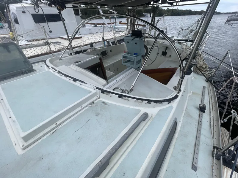 Slide: The Image of 1979 Moody 36 Classic sailboat cockpit with steering wheel, docked by the water. - 16