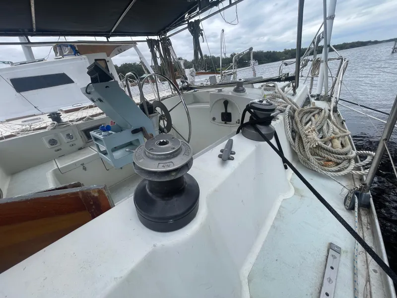 Slide: The Image of 1979 Moody 36 Classic sailboat cockpit with ropes and winches, docked by the water. - 19