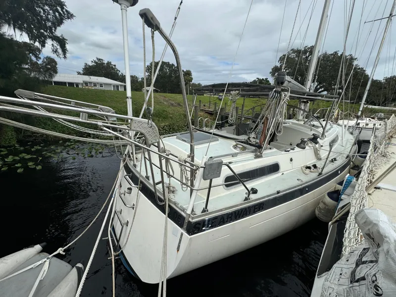 Slide: The Image of 1979 Moody 36 Classic sailboat docked on a calm river. - 22