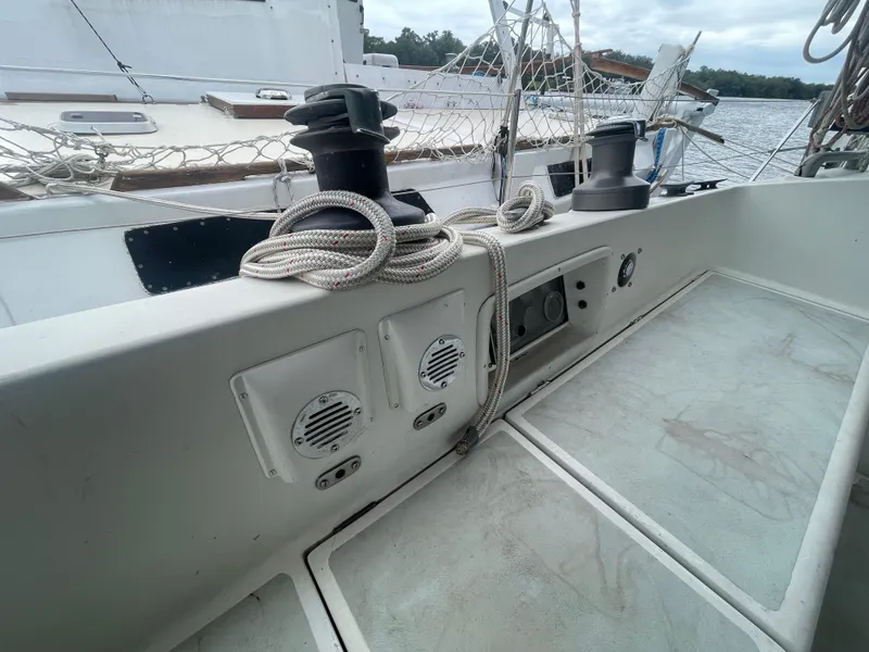 Slide: The Image of 1979 Moody 36 Classic sailboat deck with winches and ropes, docked by the water. - 29