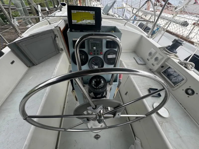 Slide: The Image of Steering wheel and navigation controls of a 1979 Moody 36 Classic sailboat. - 30