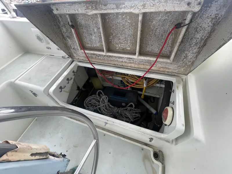 Slide: The Image of Open storage compartment on 1979 Moody 36 Classic sailboat, showing ropes and wiring. - 33