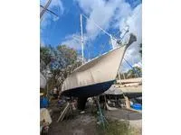 Slide: The Image of 1979 Moody 36 Classic sailboat on land under a blue sky. - 35