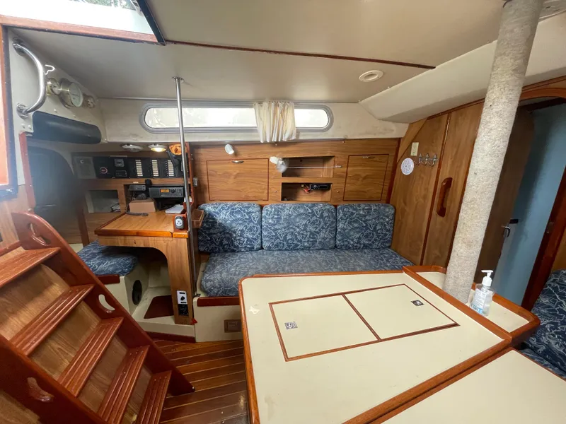 Slide: The Image of Interior of 1979 Moody 36 Classic sailboat with wooden furnishings and blue upholstery. - 38