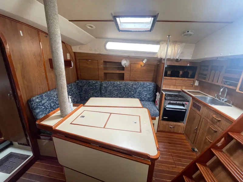Slide: The Image of Interior of 1979 Moody 36 Classic sailboat with wood finish and cozy seating area. - 39