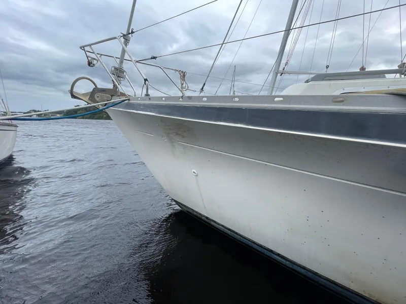 Slide: The Image of 1979 Moody 36 Classic sailboat on calm water under cloudy skies. - 4