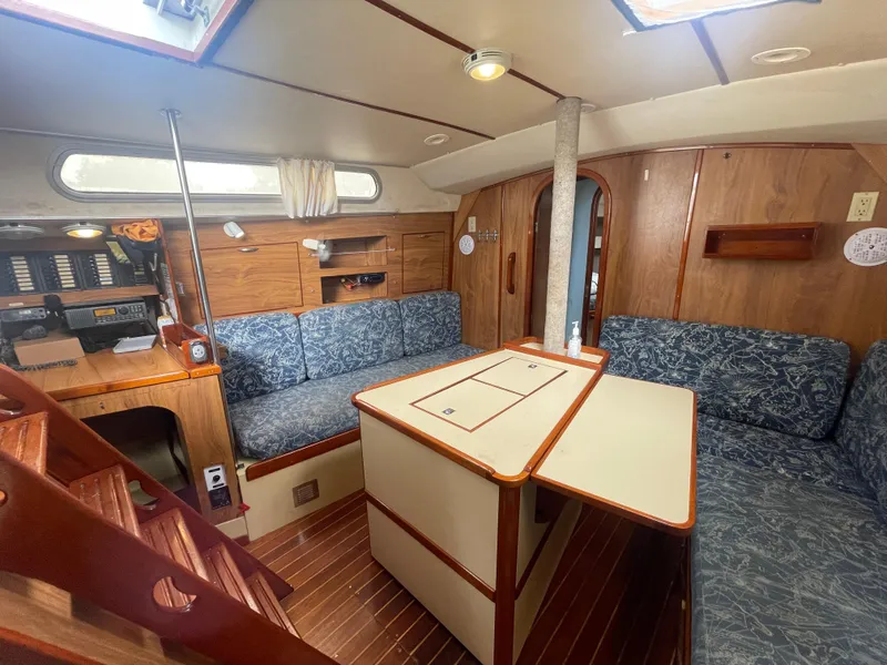 Slide: The Image of Interior of 1979 Moody 36 Classic sailboat with wood paneling and blue upholstery. - 43