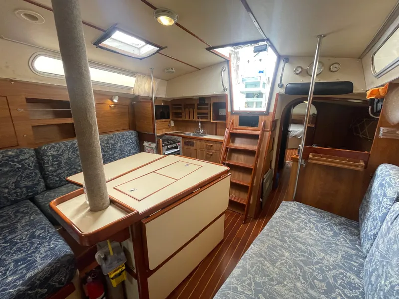 Slide: The Image of Interior of 1979 Moody 36 Classic sailboat with wood finish and seating area. - 44